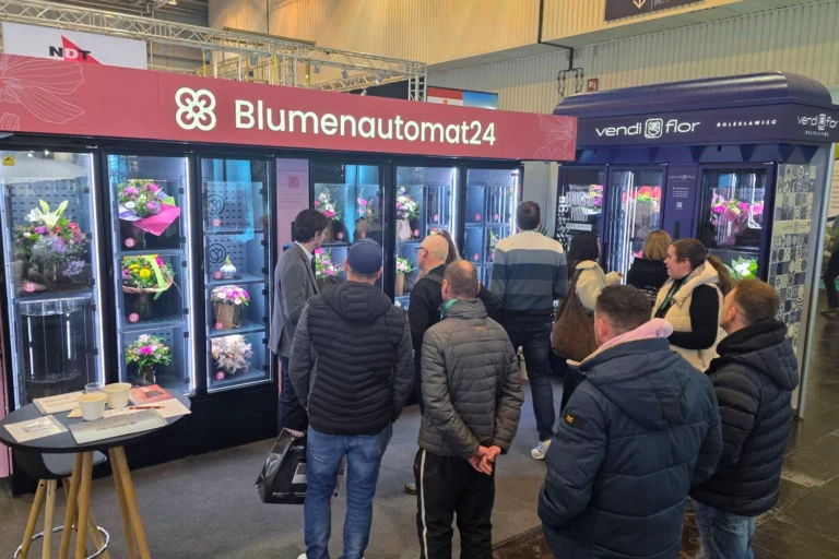 Flower vending machines displayed at IPM Essen 2026, with visitors observing bouquet vending solutions presented by Blumenautomat24 and VendiFlor.