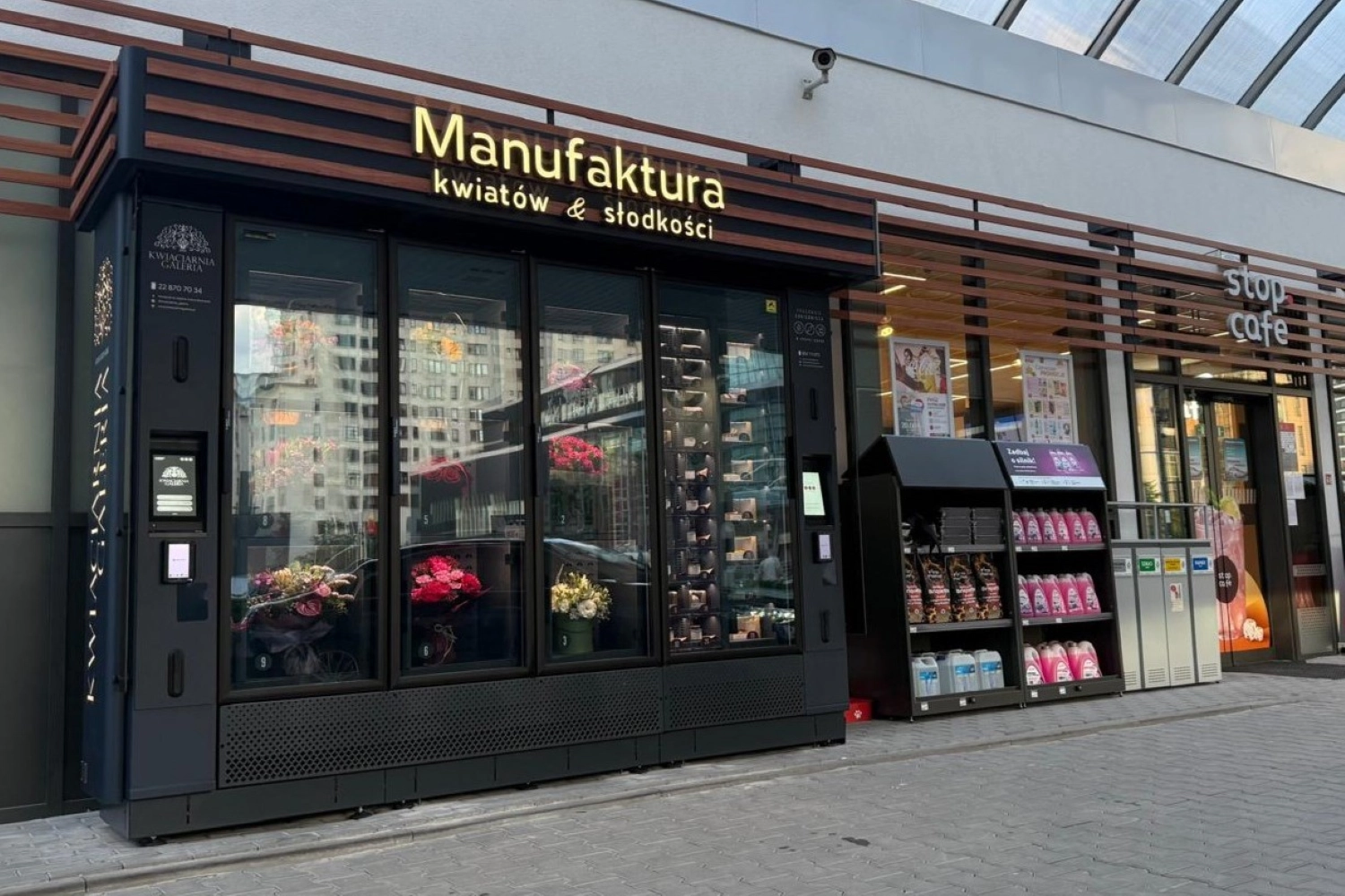 Modern flower vending machine combined with sweets and gift products, allowing customers to purchase bouquets and small gifts around the clock