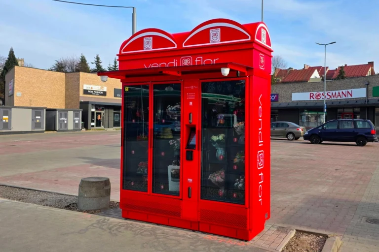 Red VendiFlor flower vending machine with illuminated advertising lightboxes and side branding, showcasing the customization possibilities of modern flower vending machines.